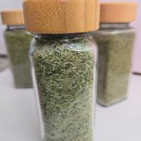 BCK Ranch freeze-dried microgreens in a glass spice jar with a bamboo lid
